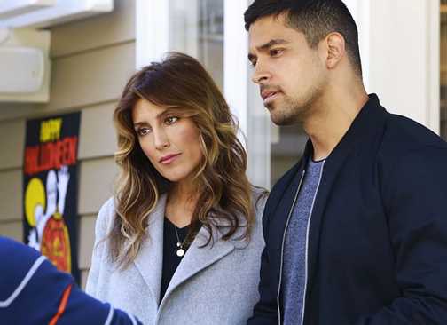 Alexandra Quinn and Nick Torres looking intently at a man in NCIS
