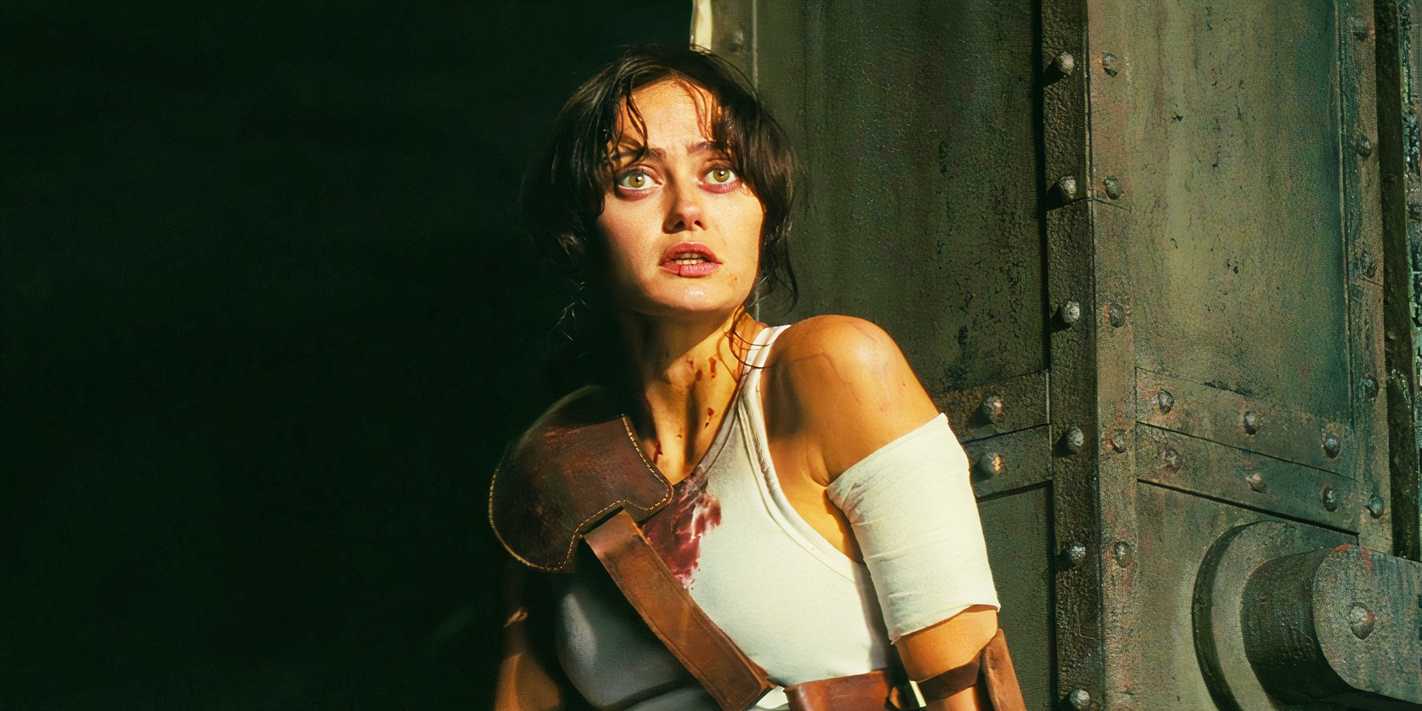 Ella Purnell as Lucy looking concerned in Fallout season 1 wearing a bloodstained shirt