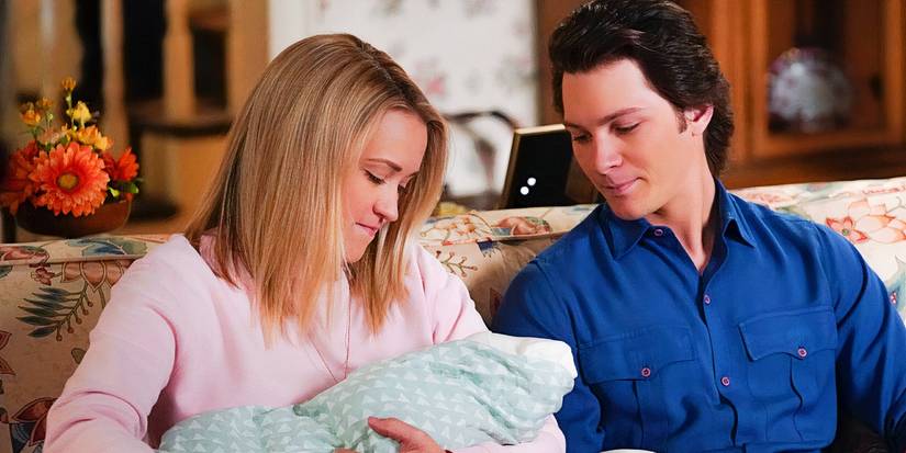 Mandy holds a baby in her arms while Georgie looks on in Young Sheldon
