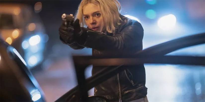 Hanna (Esme Creed-Miles) pointing a gun in Hanna