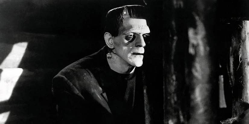 Frankenstein's Monster looking out from behind a tree in the 1931 Universal film Frankenstein. 