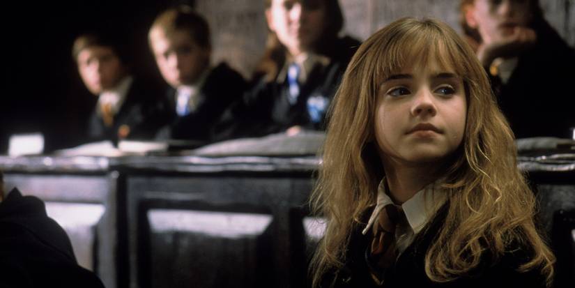 Hermione sitting in a classroom and looking confident in Harry Potter and the Sorcerer's Stone