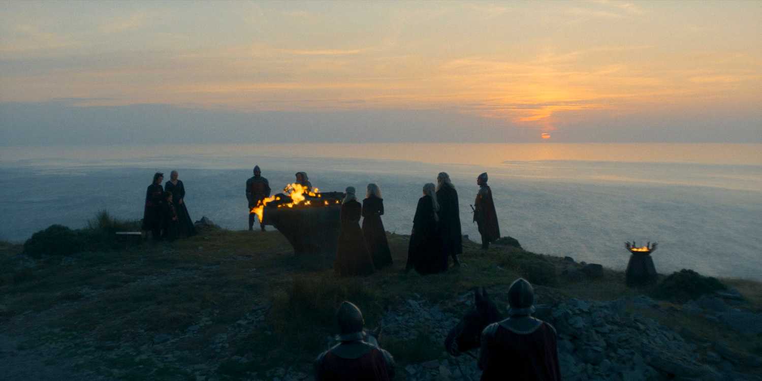 On Dragonstone, Rhaenyra and her court stand vigil around Lucerys’s funeral pyre in House of the Dragon season 2 episode 1