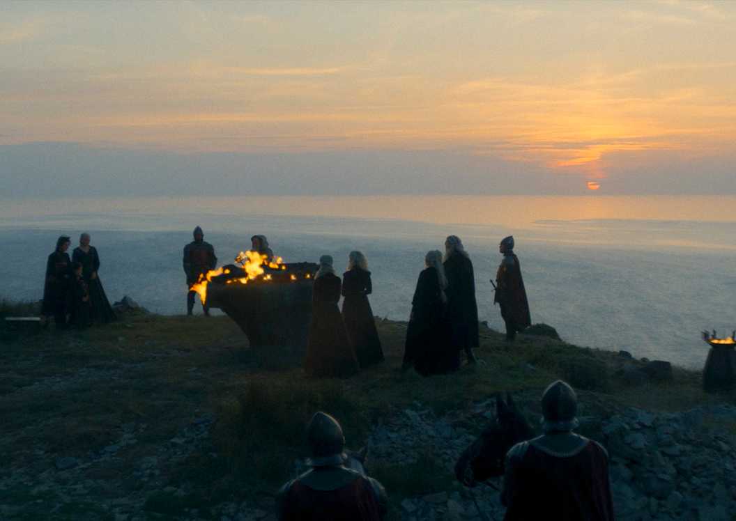 On Dragonstone, Rhaenyra and her court stand vigil around Lucerys’s funeral pyre in House of the Dragon season 2 episode 1