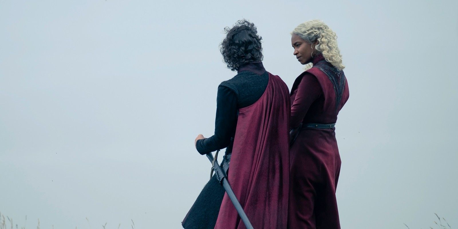 Jacaerys (Harry Collett) and Baela Targaryen (Bethany Antonia) speaking on Dragonstone with their backs to the camera in House of the Dragon season 2