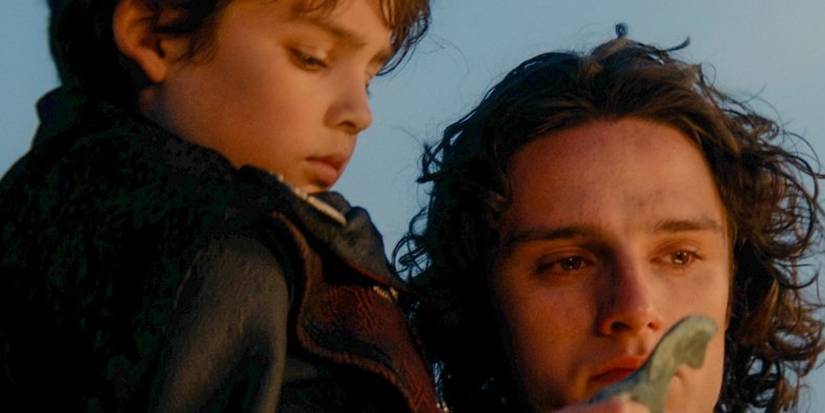 Jace (Harry Collett) and Joffrey (Oscar Eskinazi) Velaryon staring at a fire in House of the Dragon.