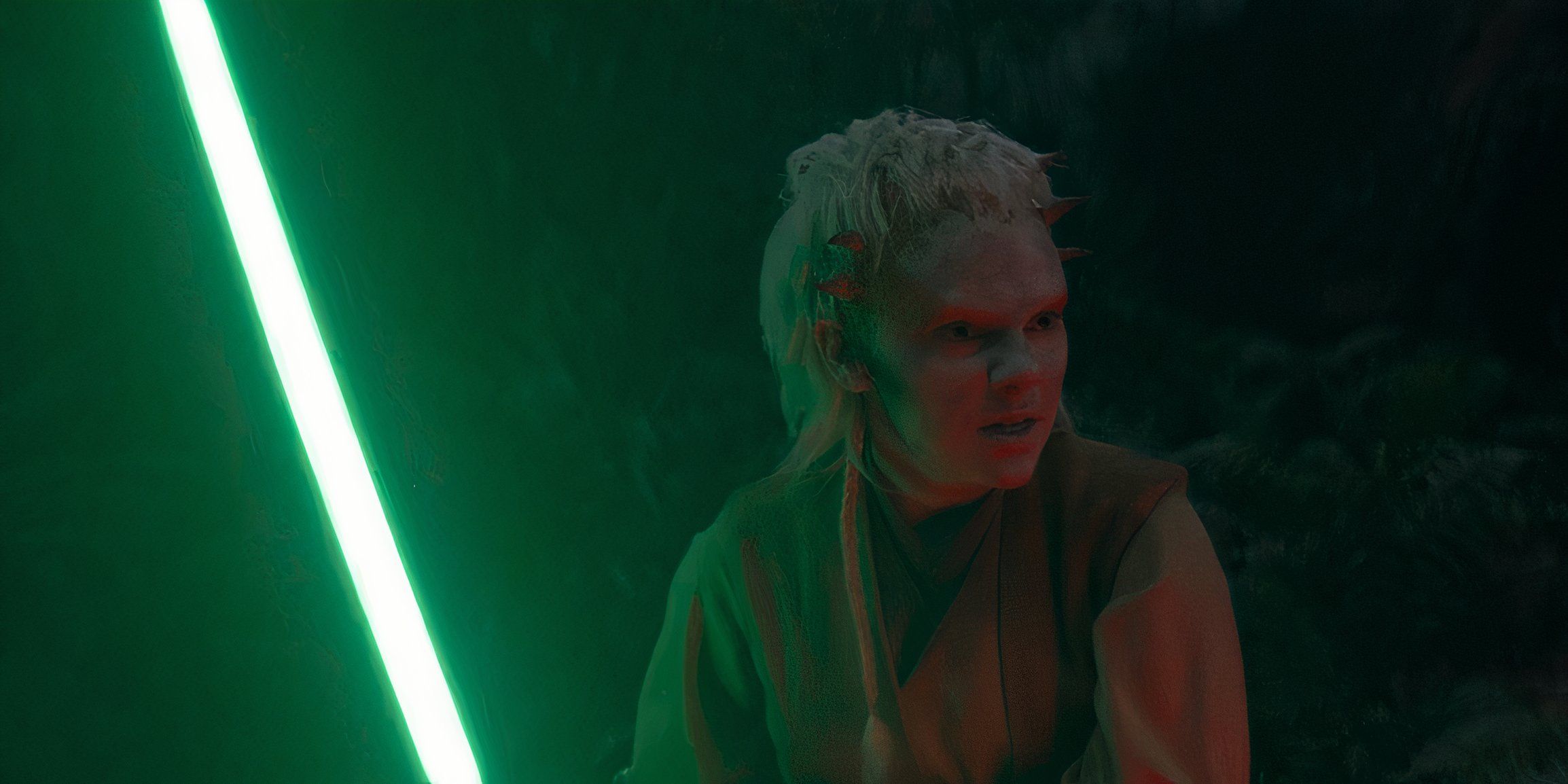 Jecki Lon (Dafne Keen) with an angry expression on her face while holding a green lightsaber in The Acolyte