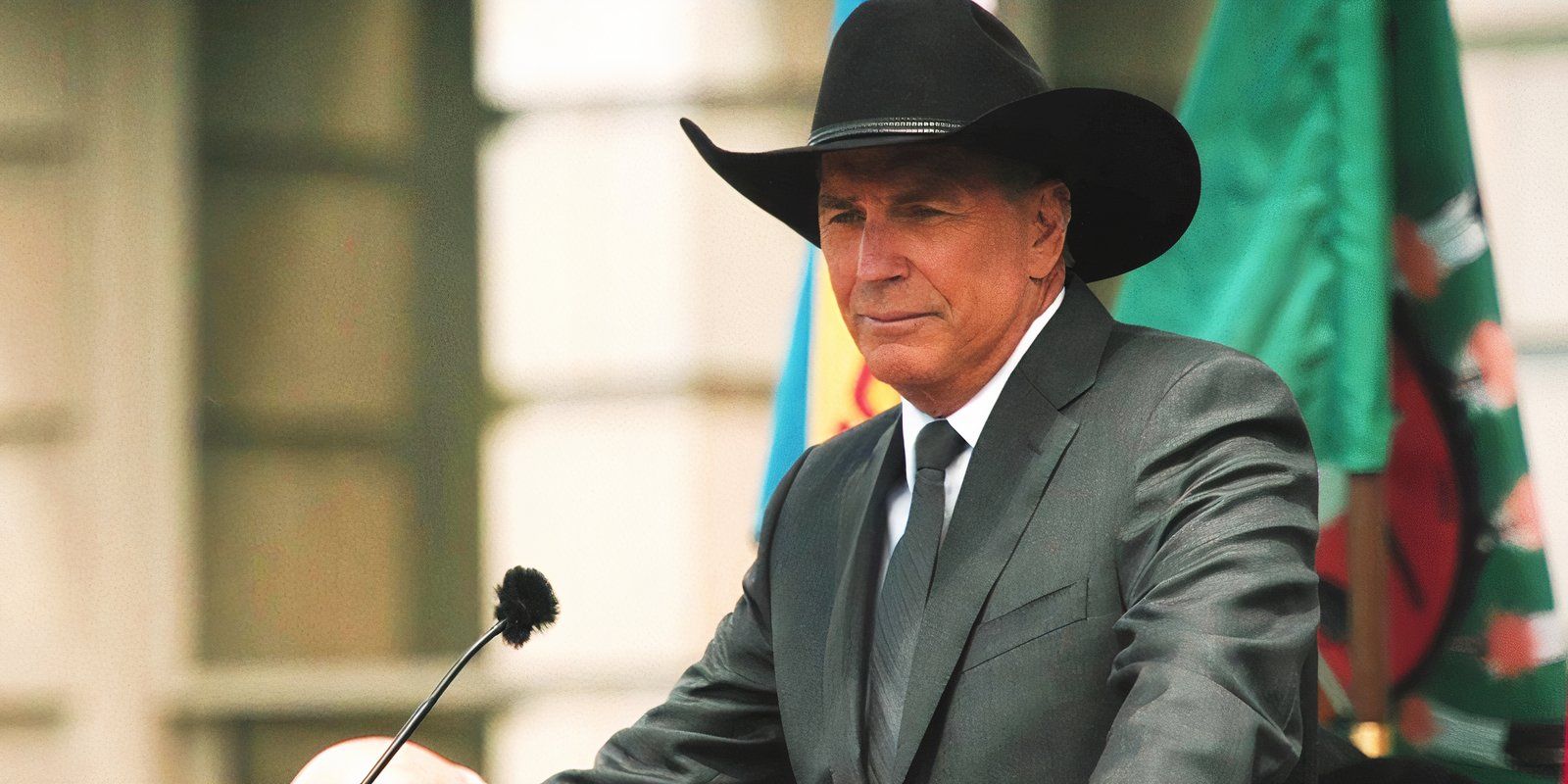 Kevin Costner as John Dutton at a podium in Yellowstone season 5 part 1