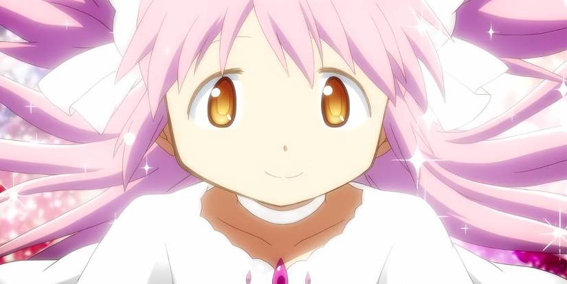 Madoka in her goddess form smiling while surrounded by white light
