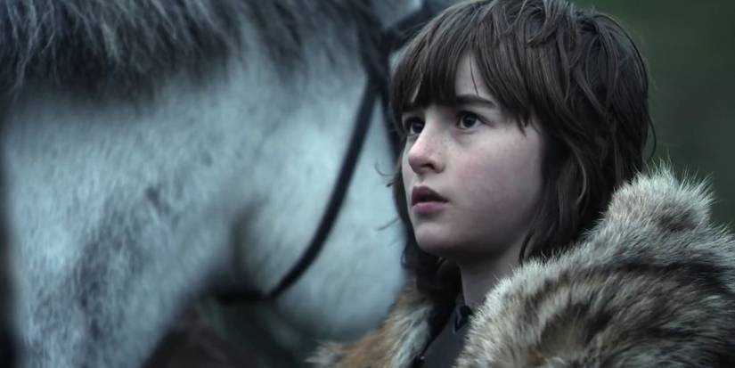 Bran Stark standing next to a horse in Game of Thrones