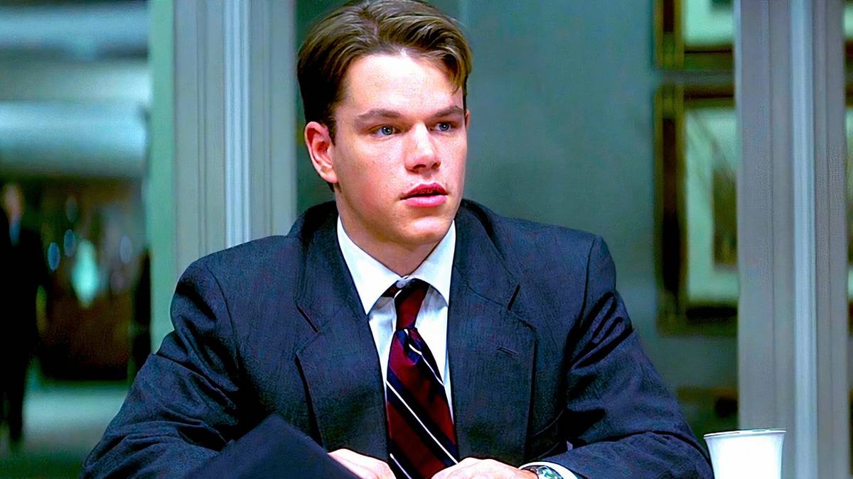 Matt Damon wearing a suit, seated and looking concerned in a scene from The Rainmaker