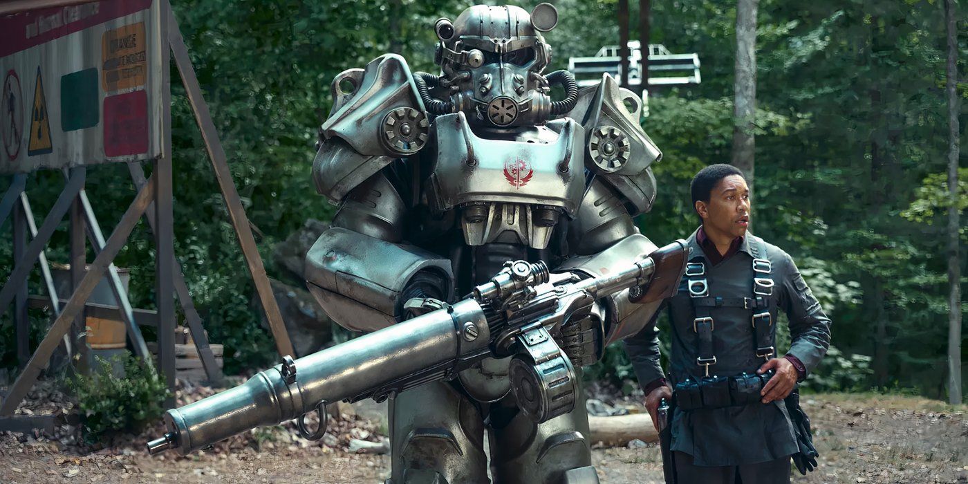 Aaron Moten as Maximus next to his armor holding a gun from Fallout