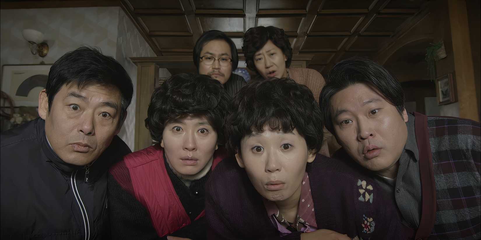 The parents of Reply 1988 all look towards the camera.