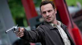 Andrew Lincoln as Rick Grimes pointing a gun in The Walking Dead, Days Gone Bye