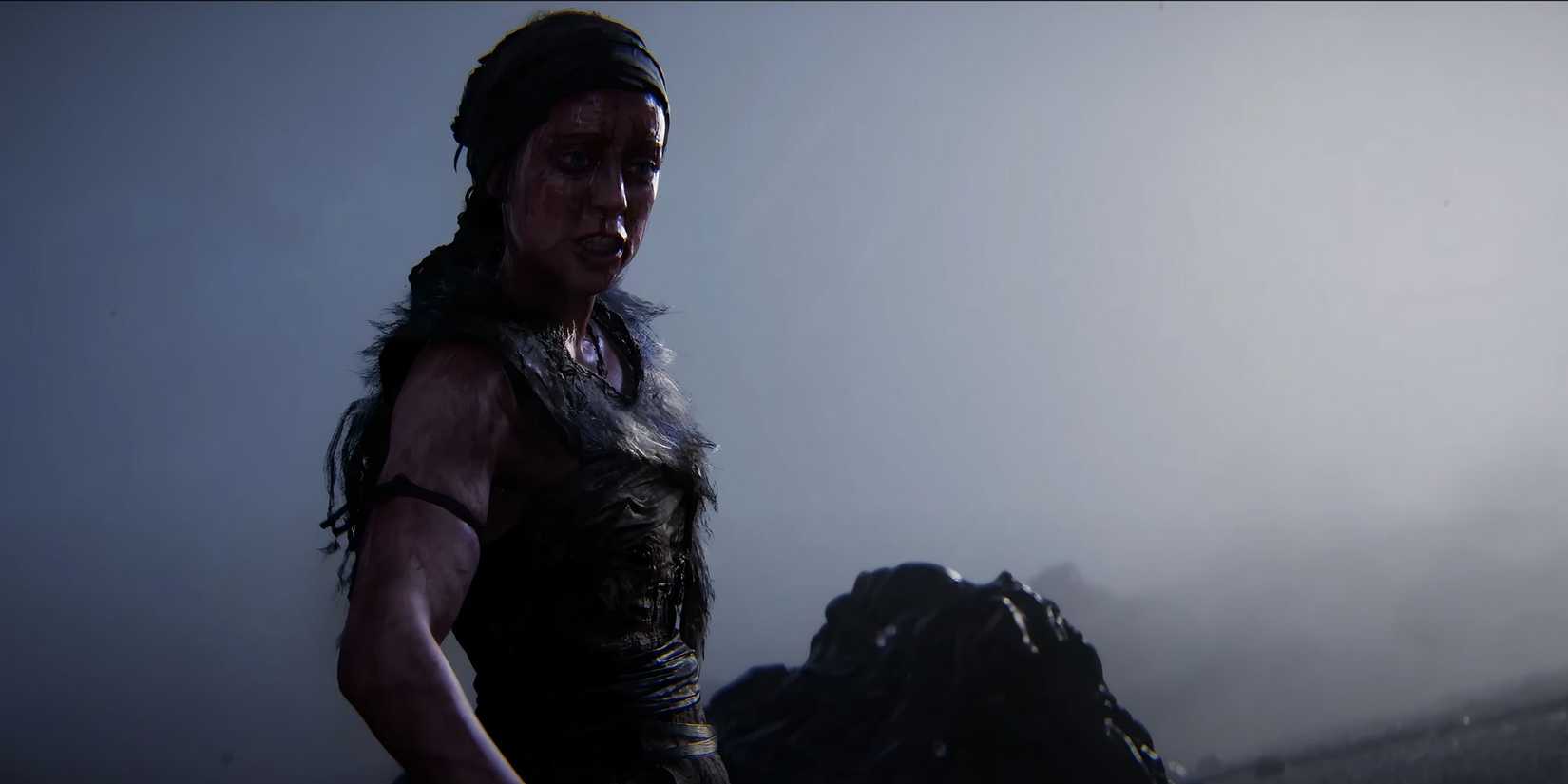 Senua looking scared with a deep fog in the background from Hellblade 2. 