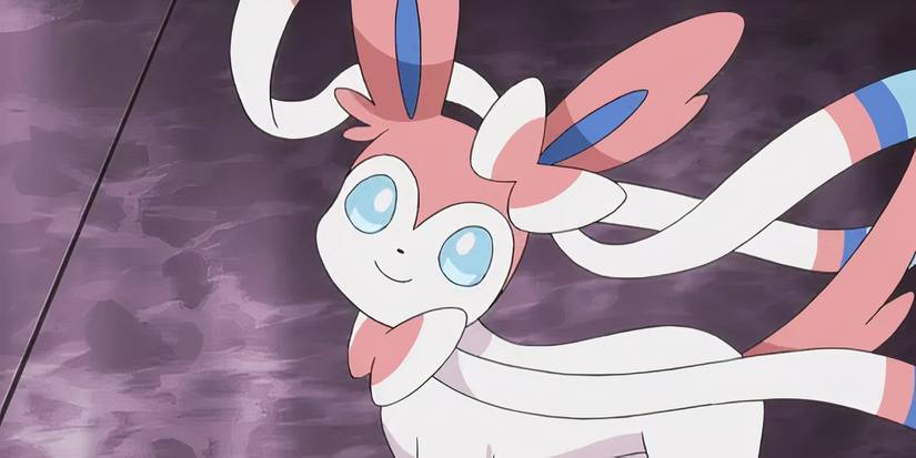 Sylveon looks ahead with its head tilted and its bows blowing in the wind.