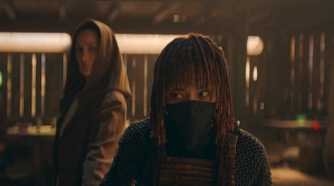 Mae (Amandla Stenberg) glancing sideways at Indara (Carrie-Anne Moss) who is behind her in The Acolyte Season 1, episode 1