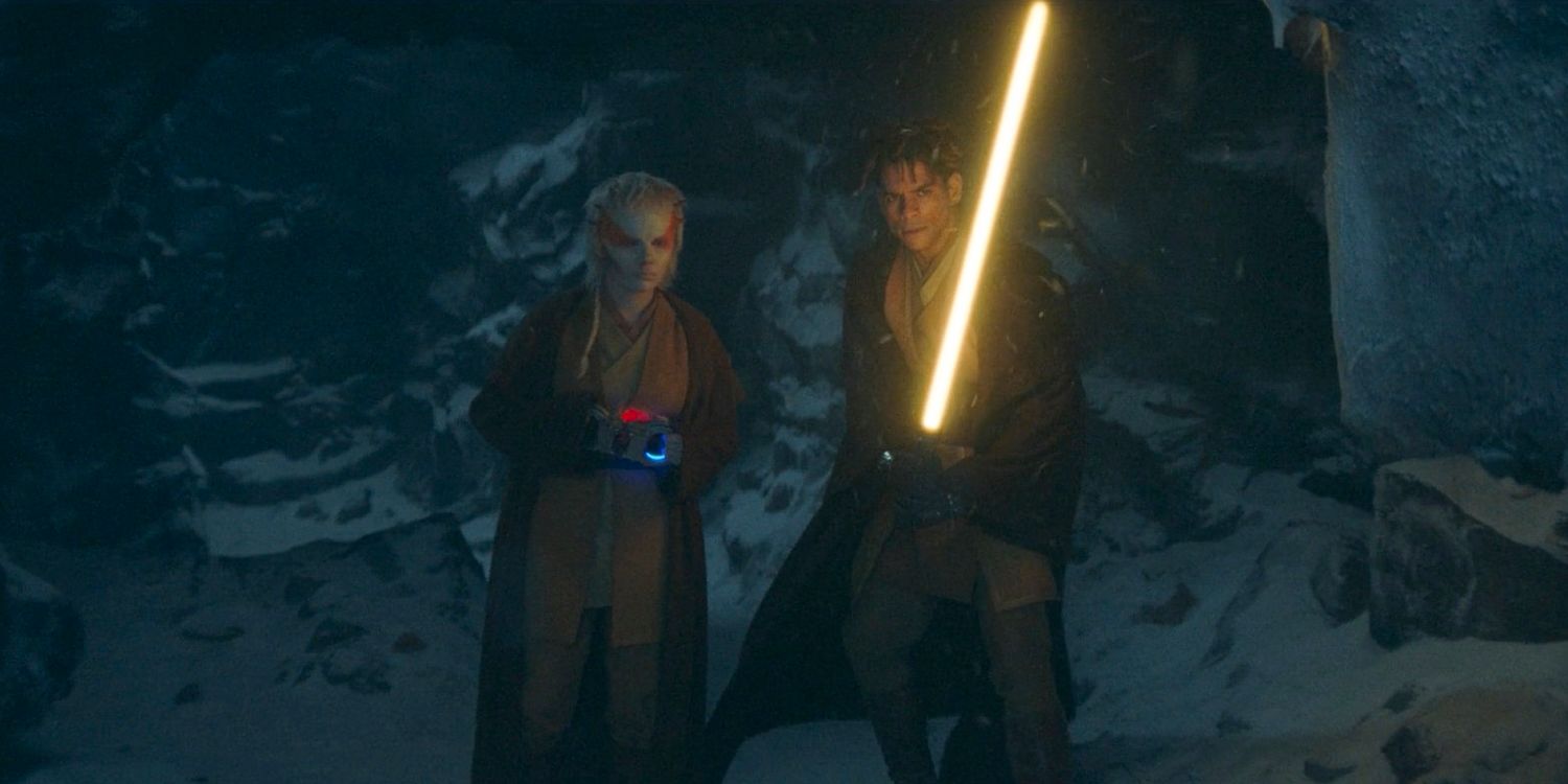 Jecki Lon (Dafne Keen) and Yord Fandar (Charlie Barnett) holding his lightsabers, cautiously walking through a cave on Carlac in The Acolyte Season 1, episode 1