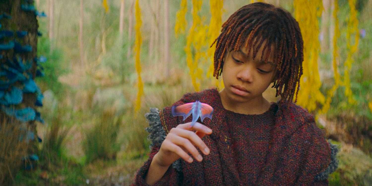 Little Osha (Lauren Brady) looking down at a creature on her hand in The Acolyte season 1 episode 3