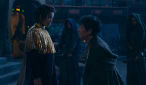 Little Osha (Lauren Brady) looking down at a younger Master Sol (Lee Jung-jae) who is kneeling in front of her in The Acolyte season 1 episode 3