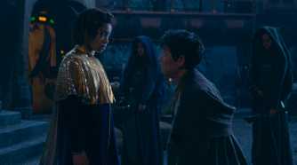 Little Osha (Lauren Brady) looking down at a younger Master Sol (Lee Jung-jae) who is kneeling in front of her in The Acolyte season 1 episode 3