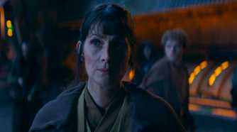 Young Indara (Carrie-Anne Moss) standing in the witches' fortress in The Acolyte season 1 episode 3