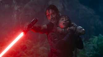 Qimir/Sith (Manny Jacinto) takes Mae (Amandla Stenberg) hostage while threatening Master Sol with his lightsaber in The Acolyte season 1 episode 5