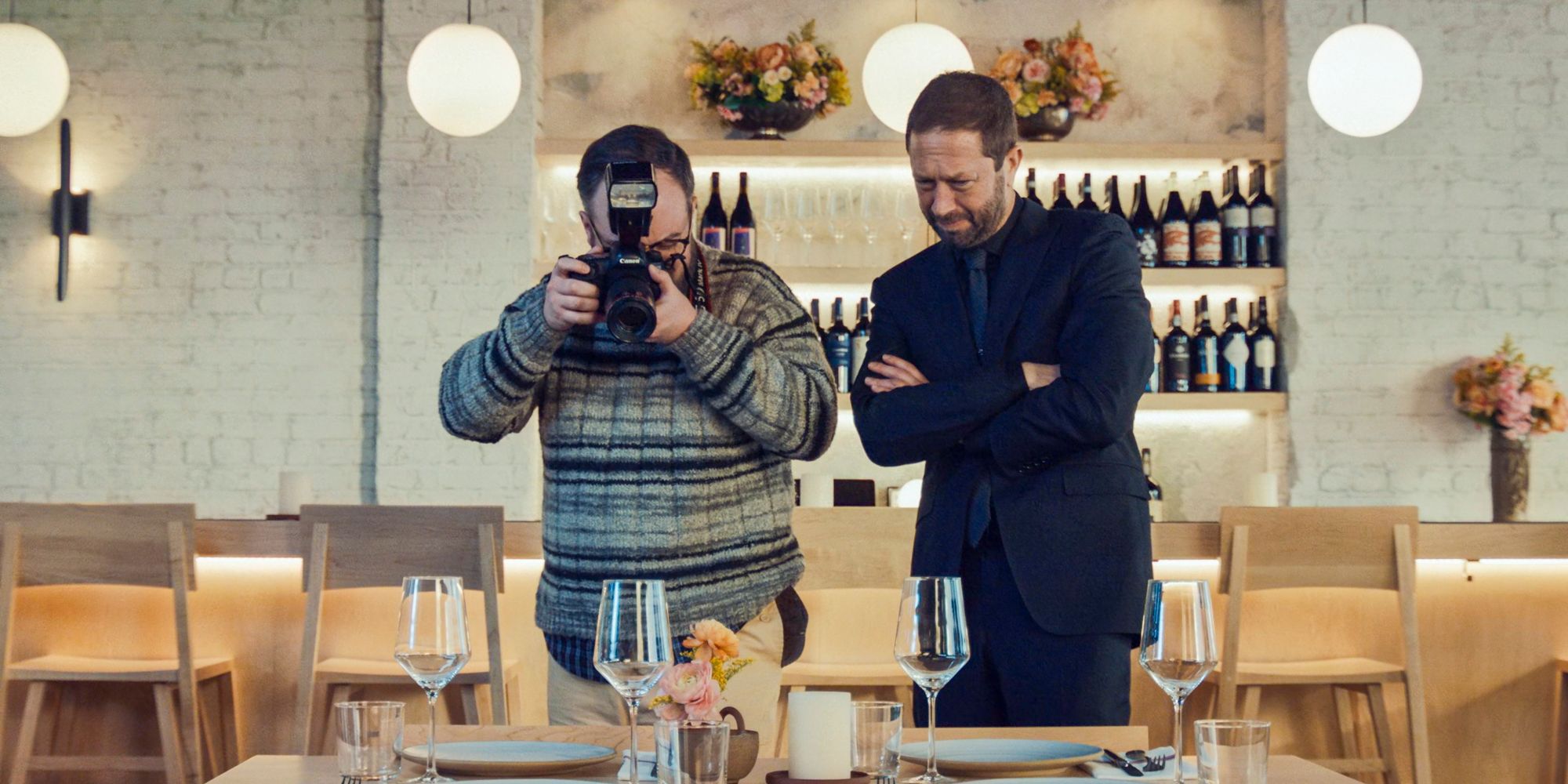 Richie (Ebon Moss-Bachrach) guiding a photographer to shoot the food of the restaurant in The Bear Season 3 Episode 5