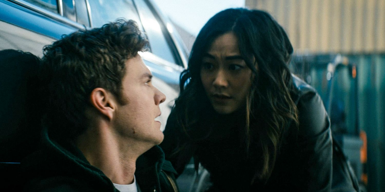 Hughie (Jack Quaid) and Kimiko (Karen Fukuhara) behind a car, taking cover from a shooting attack in The Boys season 4 episode 4