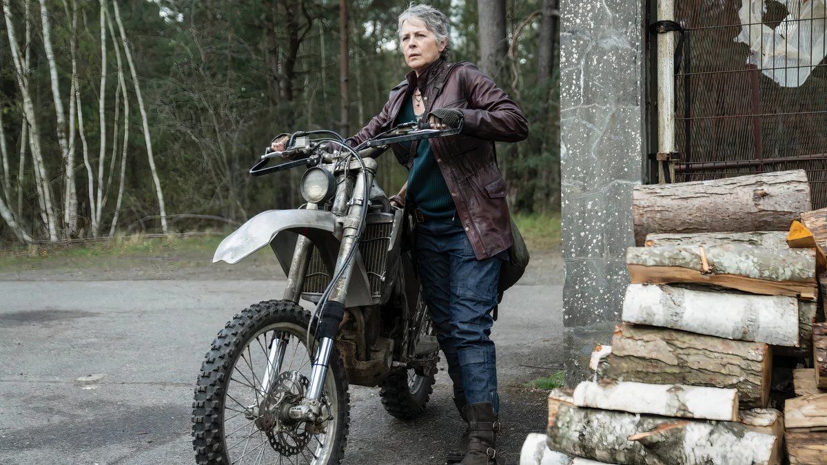 Melissa McBride as Carol next to a dirt bike in The Walking Dead Daryl Dixon season 2