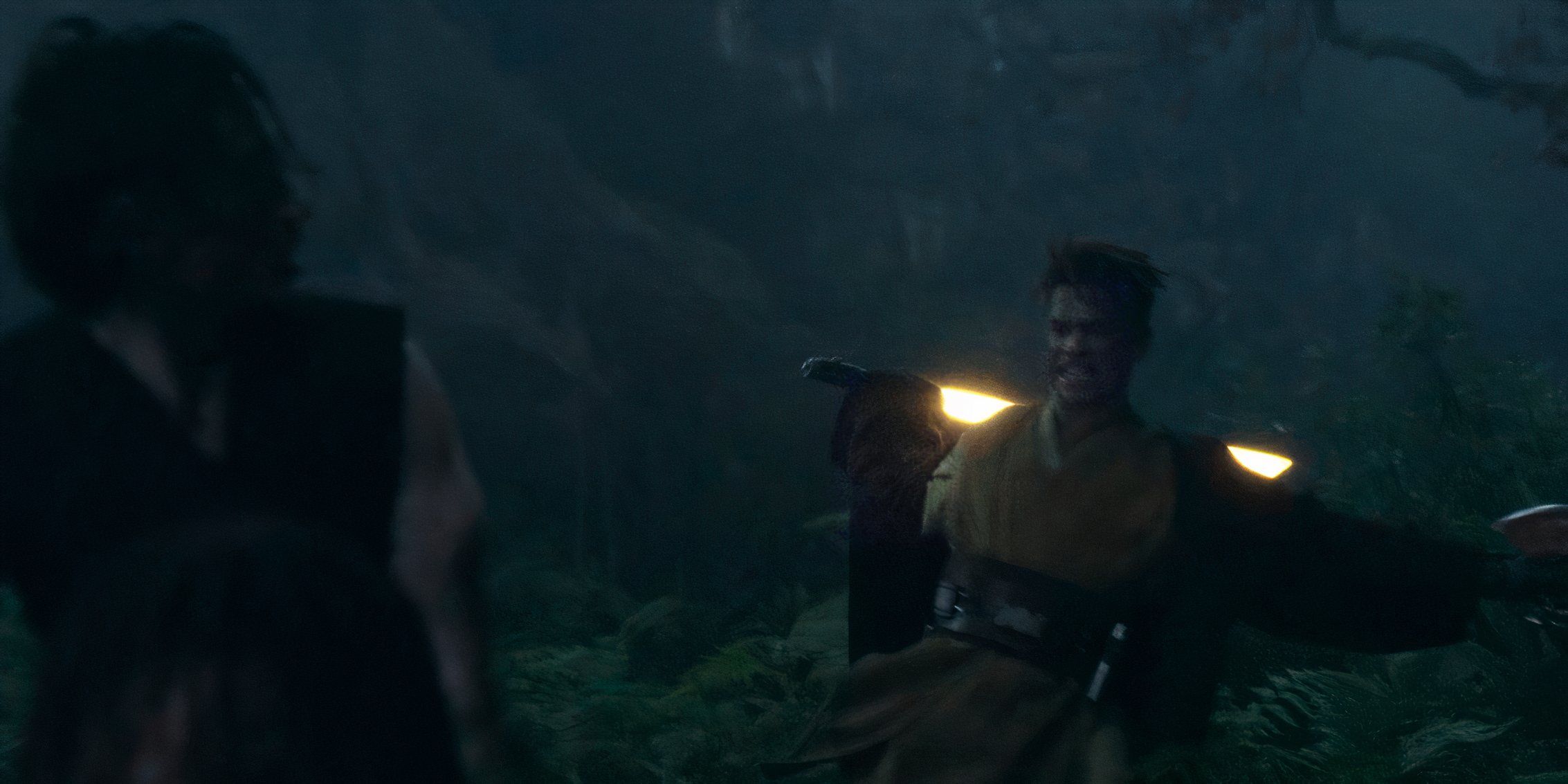 Yord Fandar (Charlie Barnett) grimaces as he prepares to swing his yellow lightsaber at the back of Qimir (Manny Jacinto) in The Acolyte