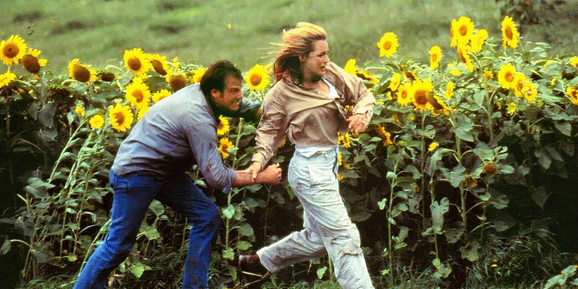 bill paxton and helen hunt run through sunflower fields in twister