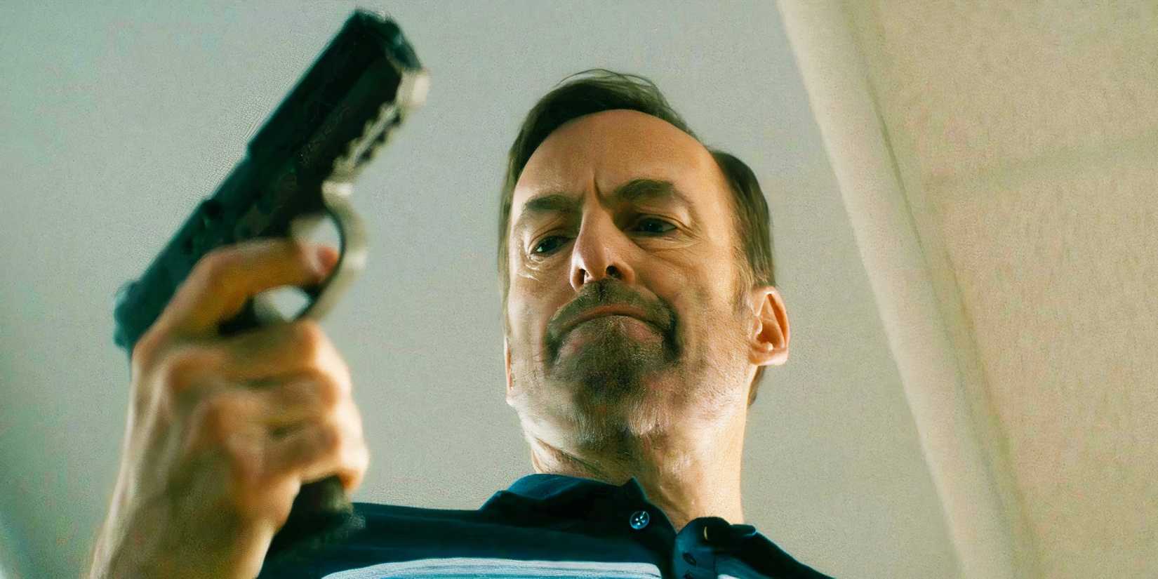 Bob Odenkirk holding a gun as Hutch Mansell in Nobody