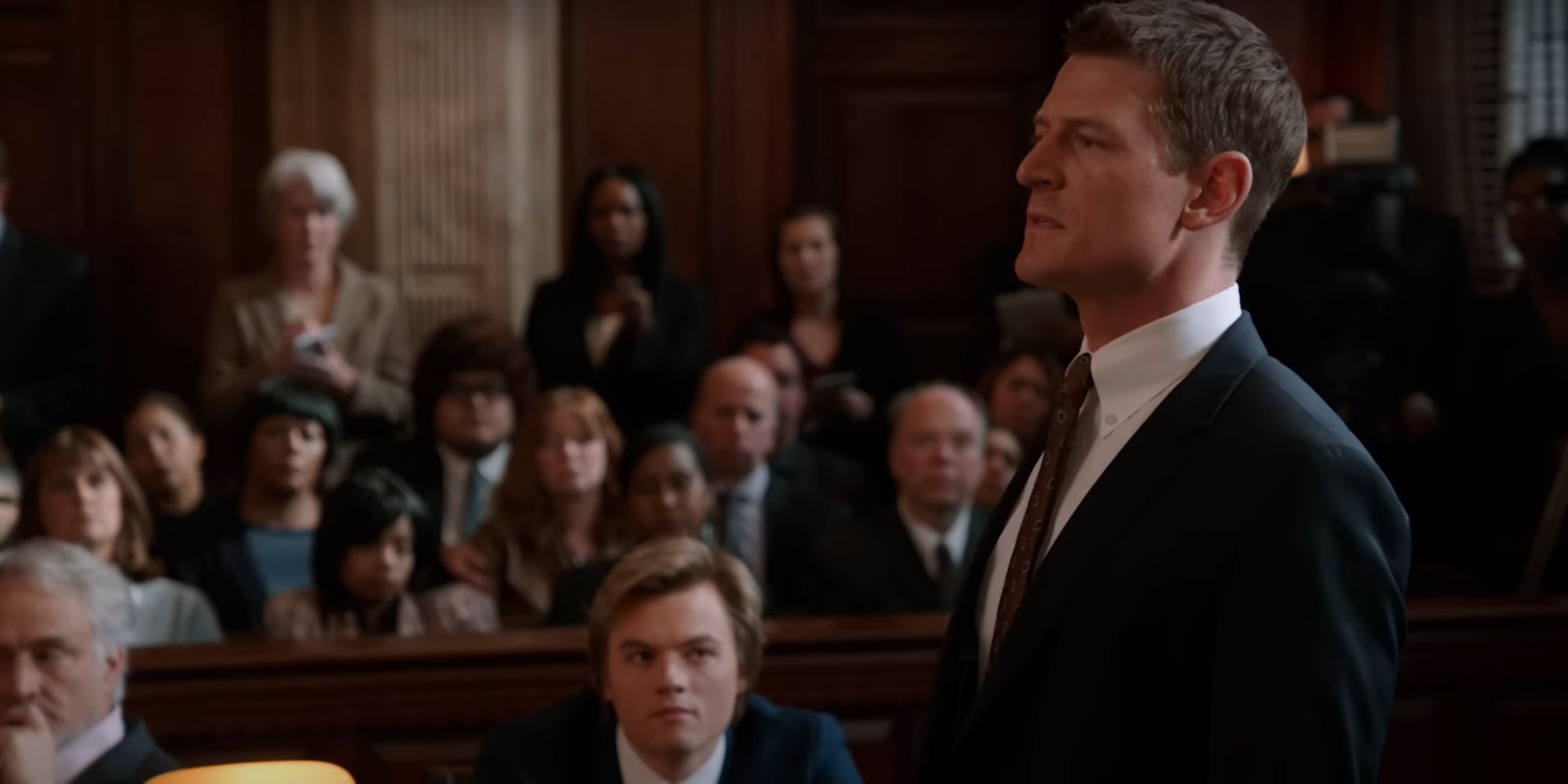 Chicago Justice Philip Winchester as SSA Peter Stone standing sideways as he tries a case