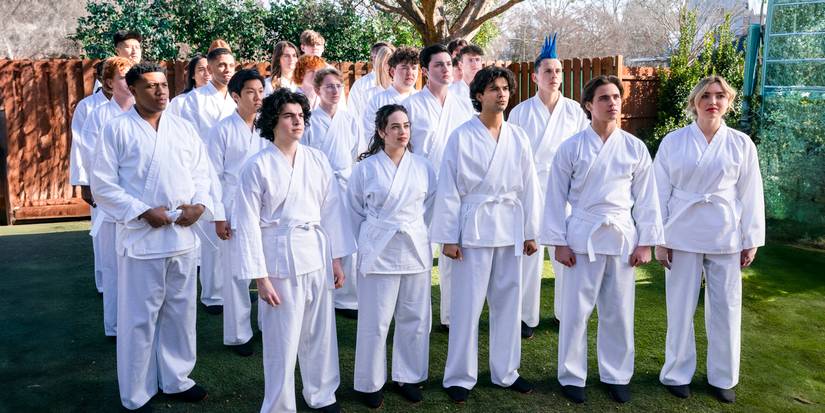 Members of the Cobra Kai dojo standing together in their white uniforms in Cobra Kai season 6 Part 1