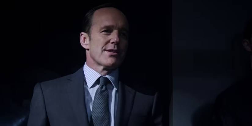 Phil Coulson in Agents of Shield talking and smiling.
