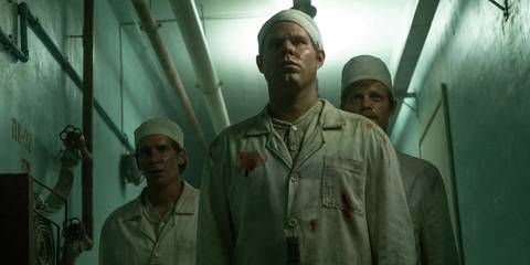 Douggie McMeekin As Yuvchenko With Two Other Workers In Blood-Stained Uniforms In Chernobyl.jpg
