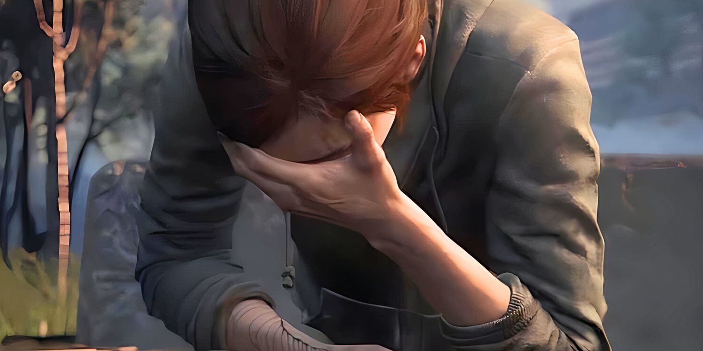 Ellie holding her head an crying in The Last of Us 2