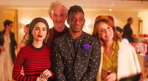 Emily (Lily Collins), Luc (Bruno Gouery), Julien (Samuel Arnold) and Sylvie (Philippine Leroy-Beaulieu) smiling in Emily in Paris season 4