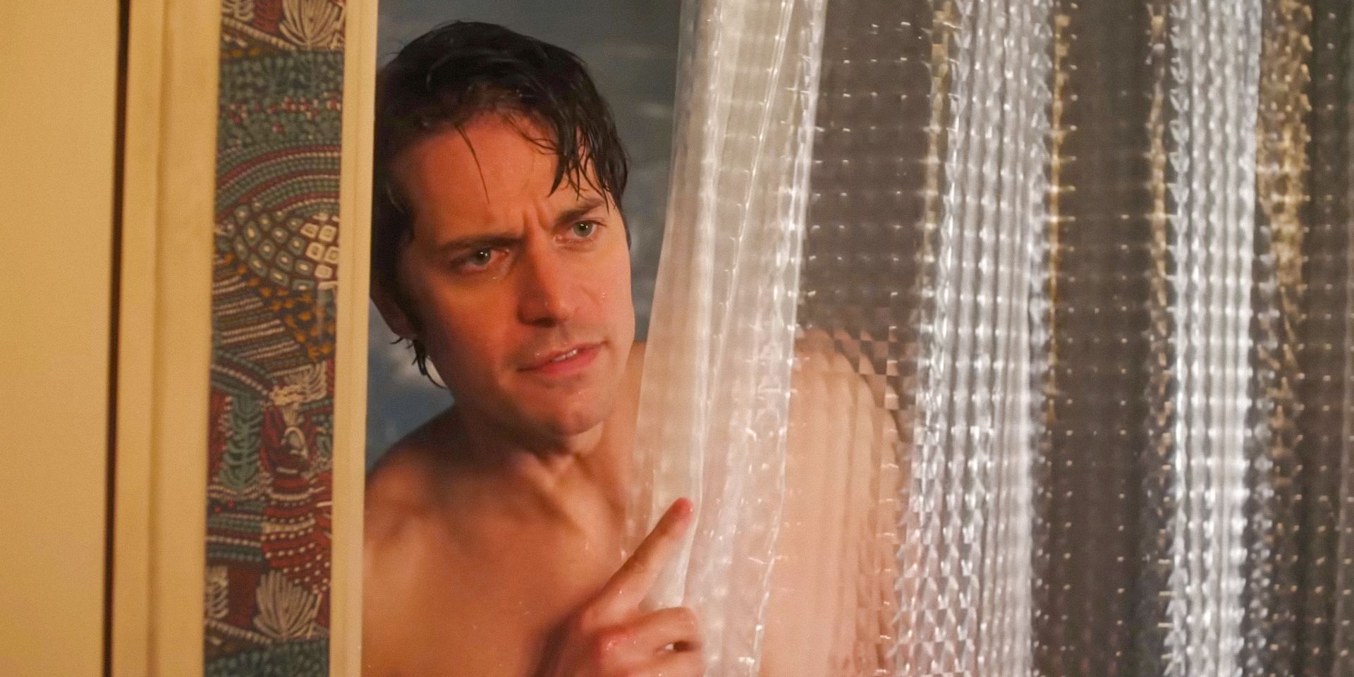 Gabriel (Lucas Bravo) peeking out from behind the shower curtain in Emily in Paris season 4