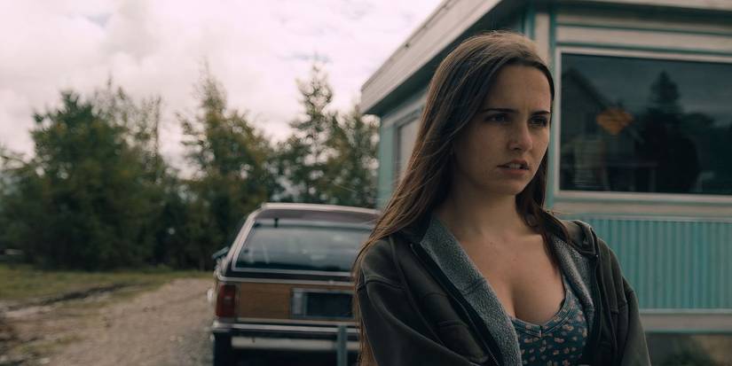 Julie Matthews looks troubled while standing behind a station wagon that's parked in front of the diner in From