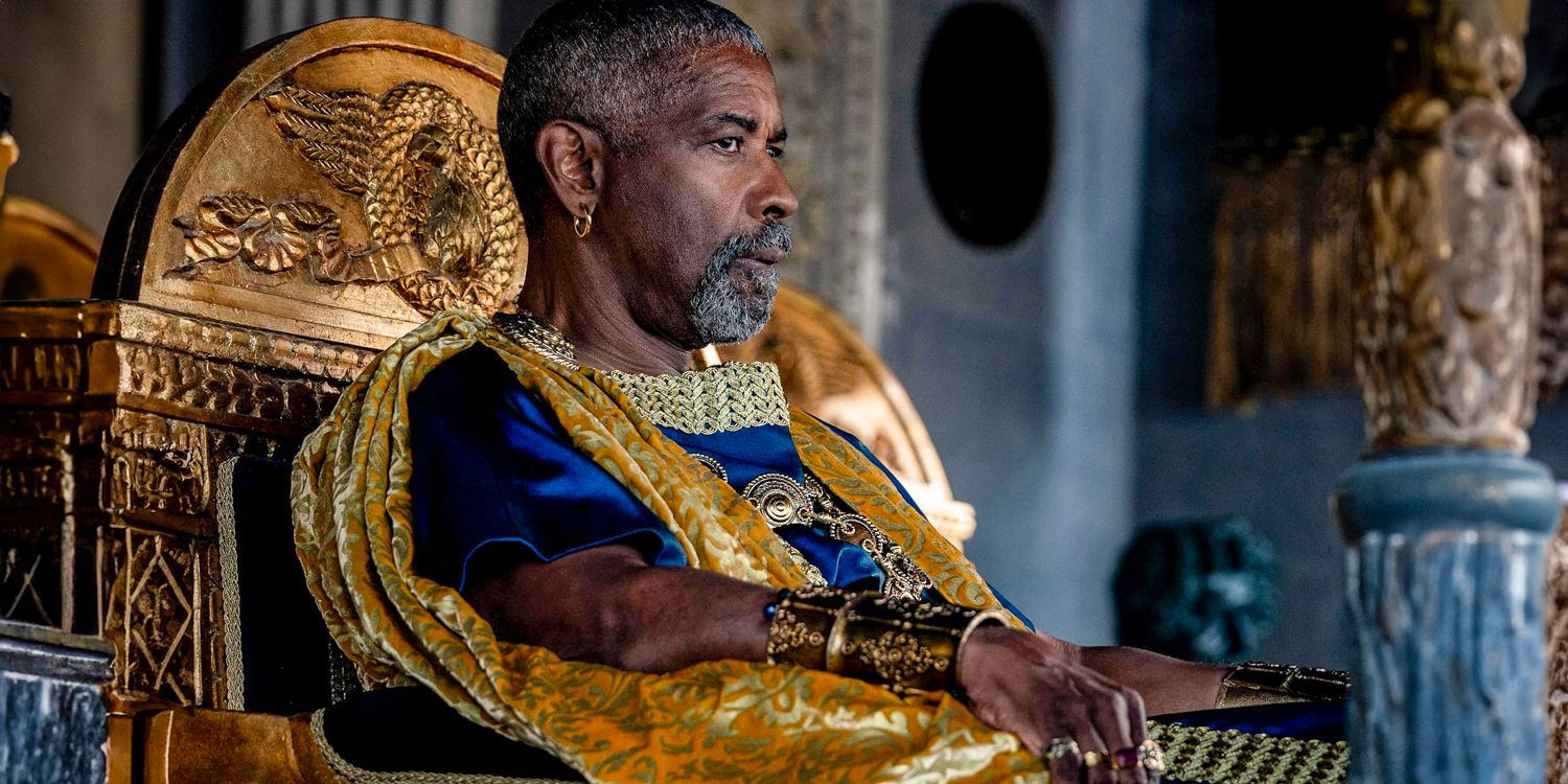 Macrinus (Denzel Washington) regally dressed and sitting in an ornate golden chair in Gladiator 2