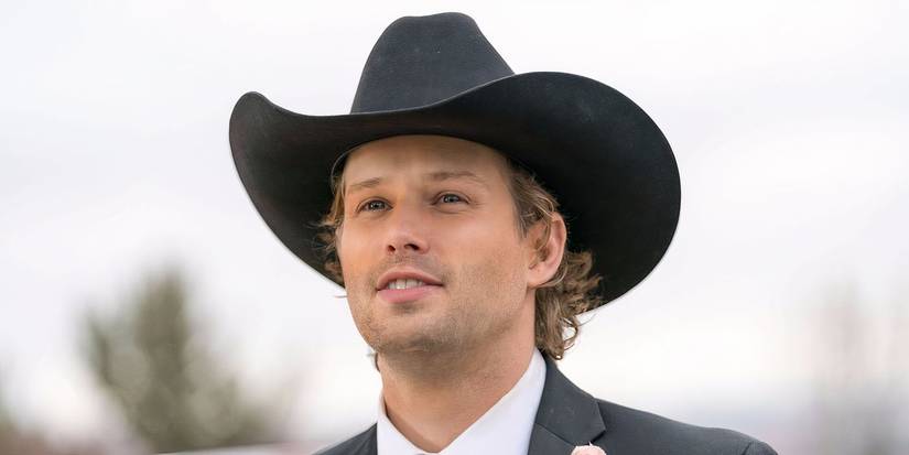 Caleb smiles while wearing a cowboy hat in Heartland