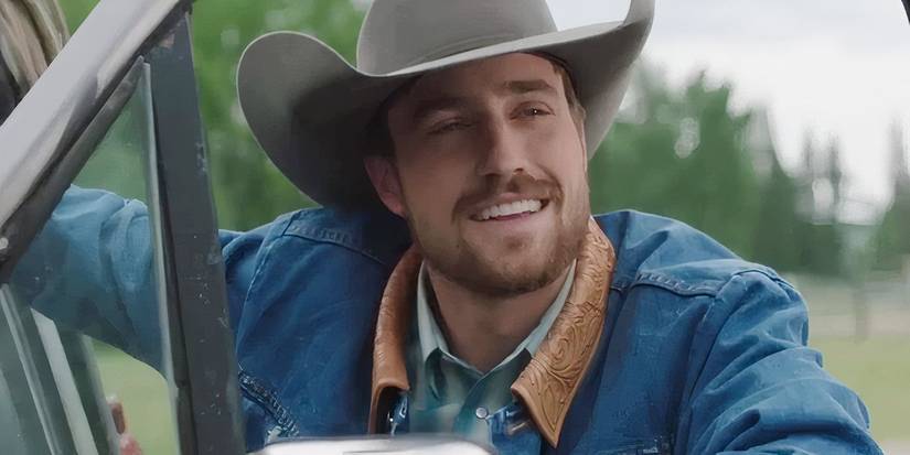 Nathan smiles while leaning on a truck in Heartland