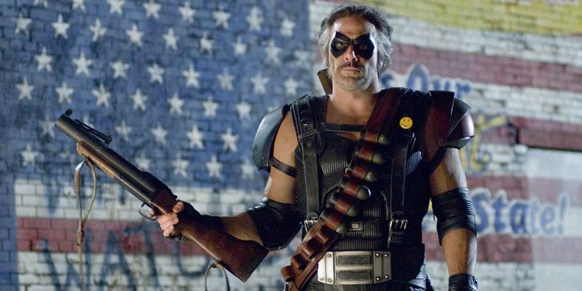 Jeffrey Dean Morgan holding a gun and dressed as The Comedian in Watchmen