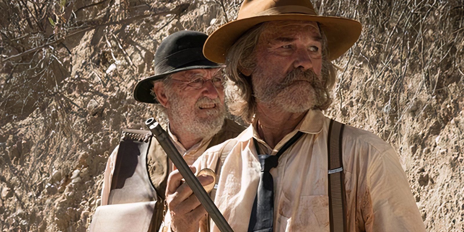 Kurt Russell standing in front of another man in Bone Tomahawk