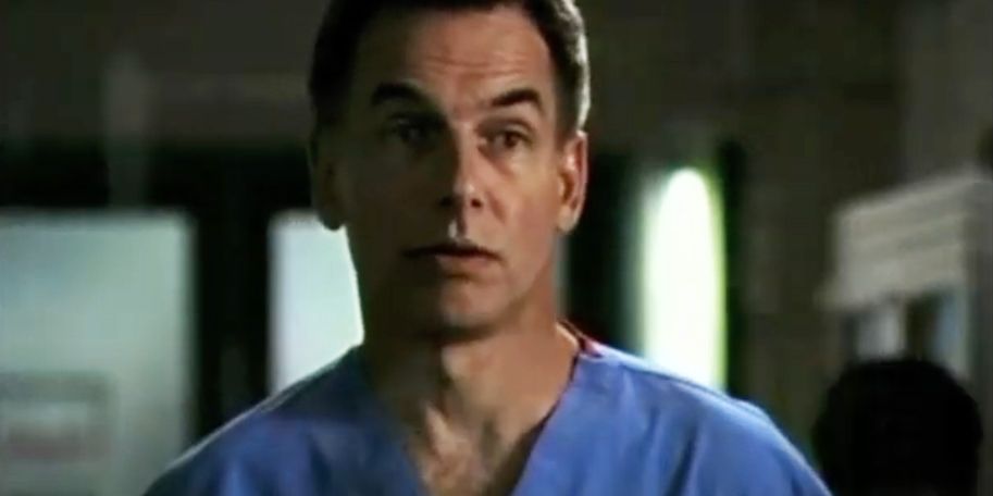 Mark Harmon looking surprised in blue scrubs in Chicago Hope