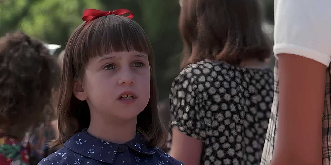 close up of Matilda talking to a student at school