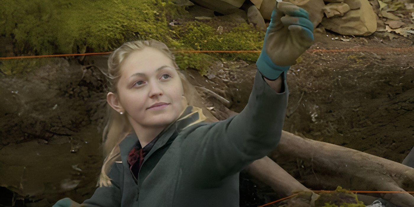 Miriam Amirault holding something up in The Curse of Oak Island.