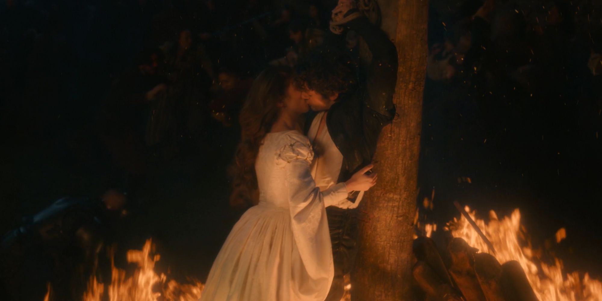 Jane and Guildford kissing as fire surrounds them in My Lady Jane